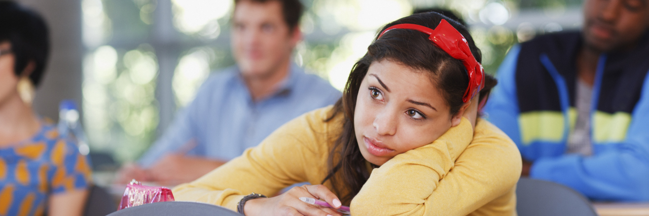 Coping With Failure in My Life With Learning Disabilities Student resting head on desk in classroom.