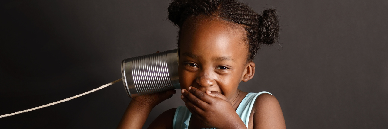 Fighting for My Daughter to Receive an Autism Spectrum Diagnosis Little girl covering her mouth laughing