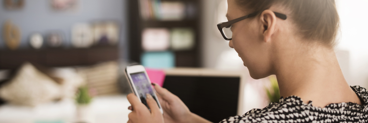 Tips for Calling Health Insurance Companies and Your Medical Team woman on phone, near her desk