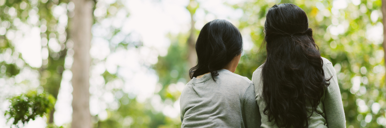 Letter to a Friend Recently Diagnosed With PTSD two friends are sitting together in the park