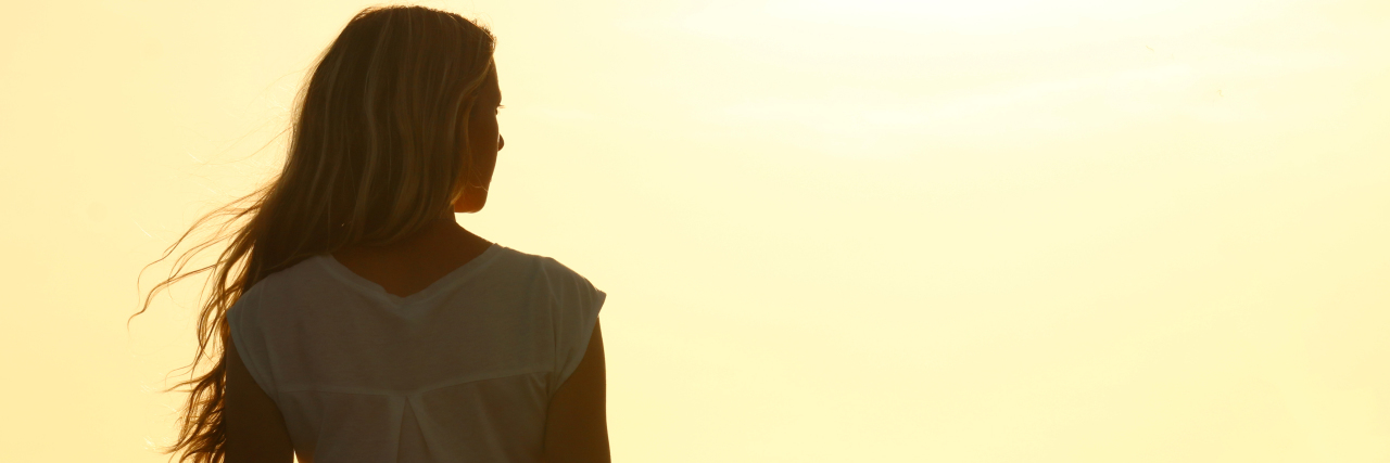 Planning Outings When You Have Fibromyalgia Woman enjoying sunset on the beach.