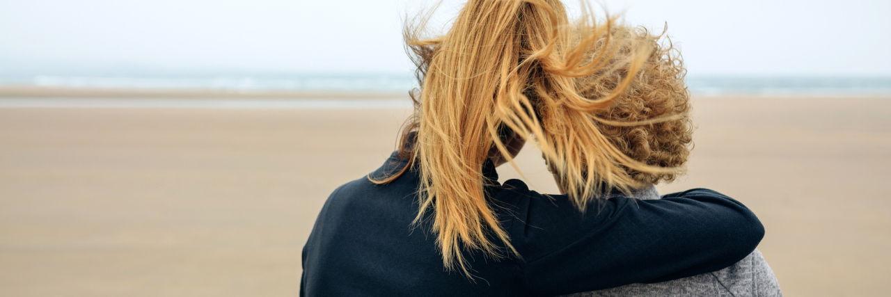 Study Finds Alzheimer's Family History Leads to Signs Before Onset Back view of senior and young woman looking at sea on the beach in autumn