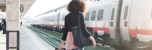 Young woman waiting for the train on station platform