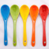 Row of rainbow spoons.