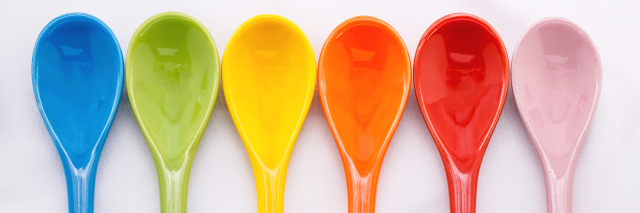 The Challenges of Being LGBT+ With Chronic Illness and Disability Row of rainbow spoons.