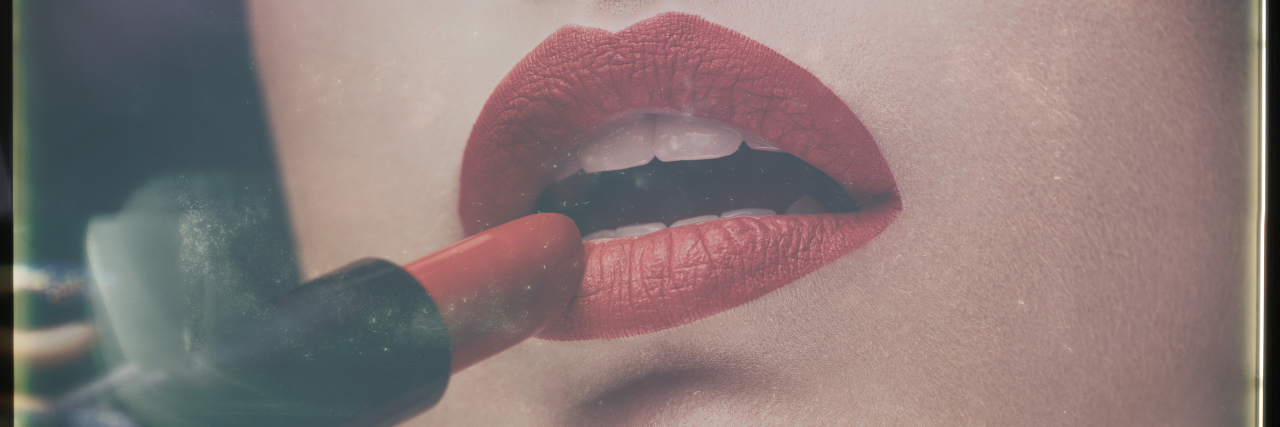 Red lips, woman putting on lipstick.