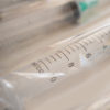 Disposable plastic syringes with needles in package.