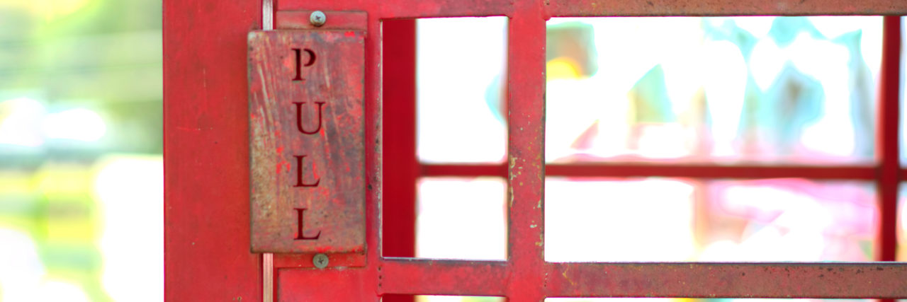 Please Ask Before Helping Someone With a Disability PULL sign on red steel door.