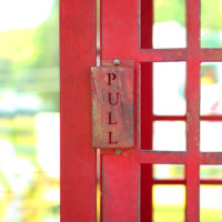 PULL sign on red steel door.