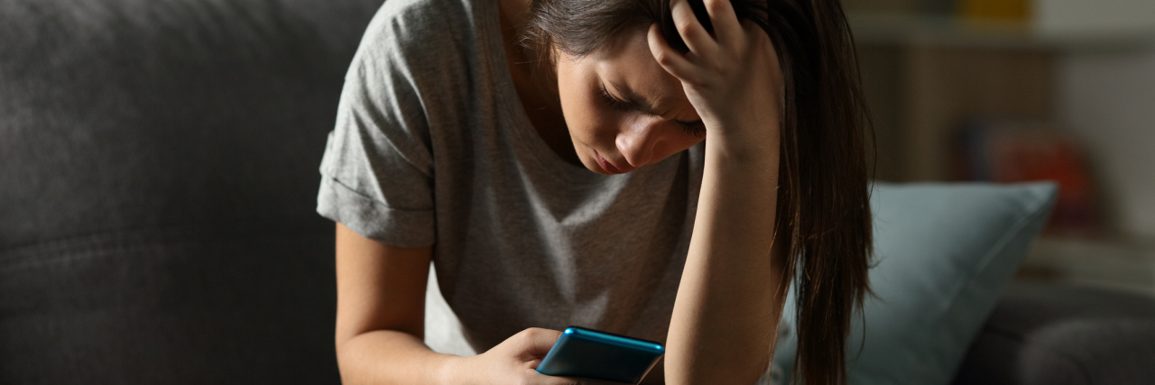 woman looking at her photo worried and sad