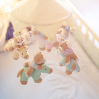 a close-up of a baby mobile hanging in a crib.