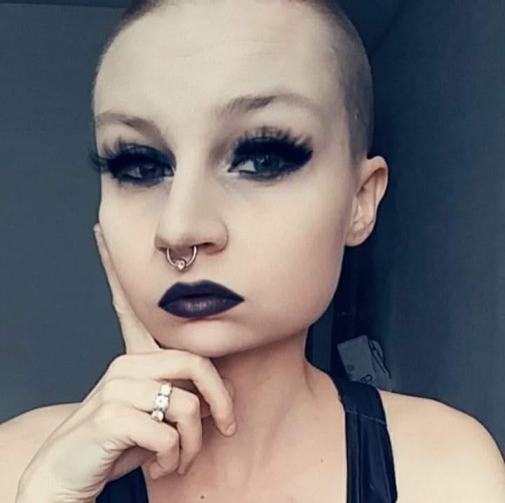 bald woman with heavy eye makeup
