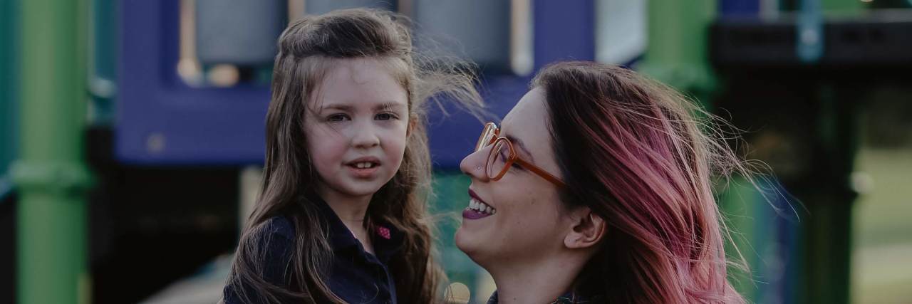 Parenting a Child With POLG and Mitochondrial Disease: Facing Reality the author smiling with her daughter, Evelyn