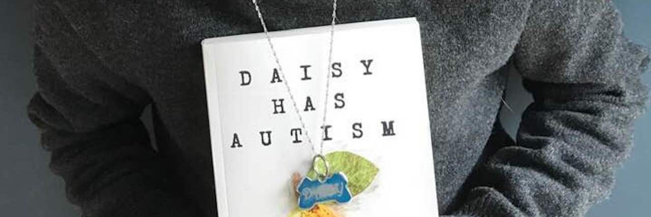Prioritizing Special Education Funding to Serve All Students Girl holding a copy of "Daisy Has Autism"