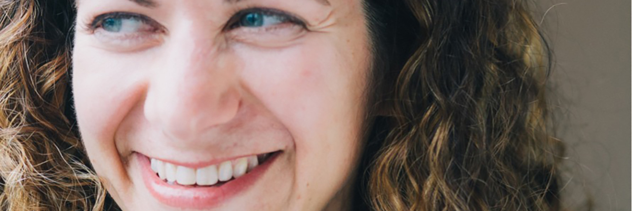 How to Choose an Audiologist If You Have Hearing Loss Melissa Platt wearing a polka dot blouse and green cardigan. She is smiling.