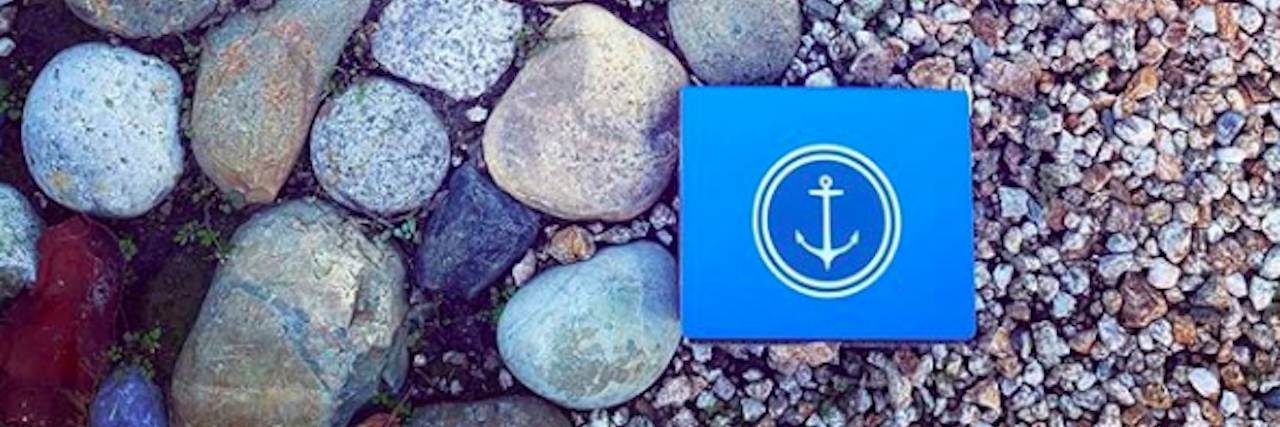 Find Your Anchor's Blue Boxes Support People Feeling Suicidal Find Your Anchor suicide prevention box on a bed of rocks and pebbles