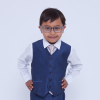 Little boy with Down syndrome looking sharp wearing a suit, hands on hips.
