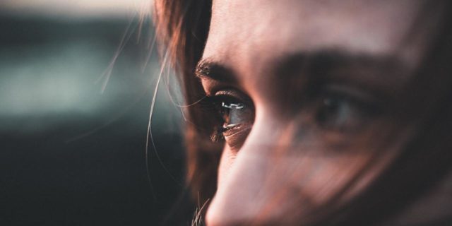 close up photo of woman crying and tears in eyes