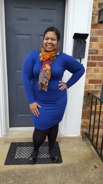 the author standing in front of a door and smiling