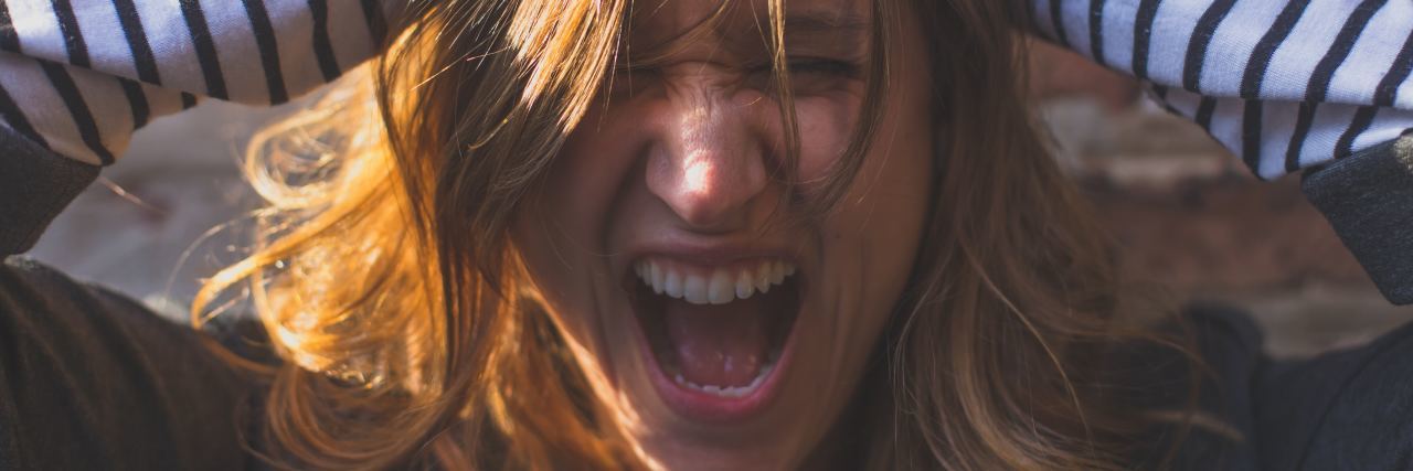 What It's Like to Live With Emotional Intensity photo of woman with hands in hair screaming