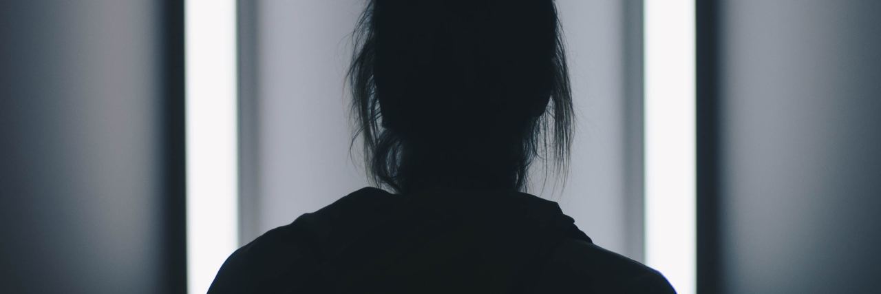 The Reality of PTSD Flashbacks During the Trump Presidency black and white photo of woman framed against white lights in square formation