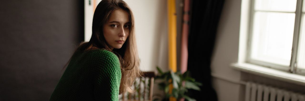 Lessons Learned From Living With Depression photo of sad looking girl on chair in empty room