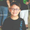 Boy with Down syndrome smiling at camera