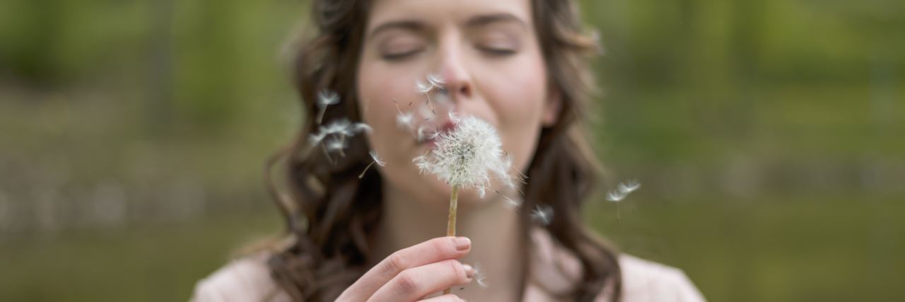 Read This If You Attempted Suicide and You're Sad You Didn't Die photo of woman blowing dandelion with eyes closed
