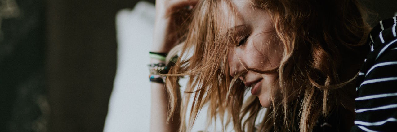 14 Things You Do When You're Socially Isolated by Illness A woman stuck in bed, her hair on her face