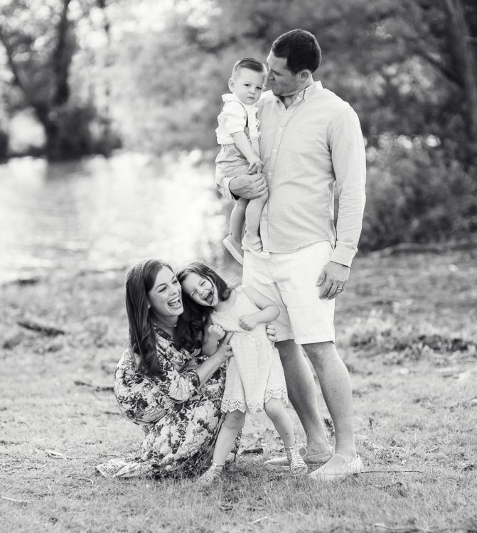 family smiling outside