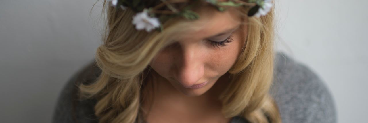 photo of young woman with blonde hair and flower crown
