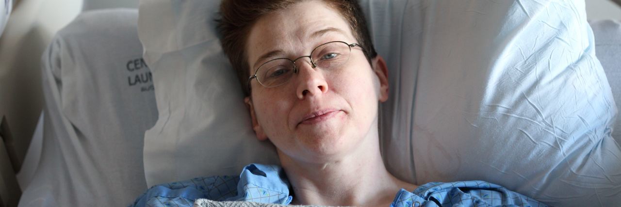 The Effect Patient Profiling Had on My Health Care photo of hospital patient in bed looking at camera and smiling