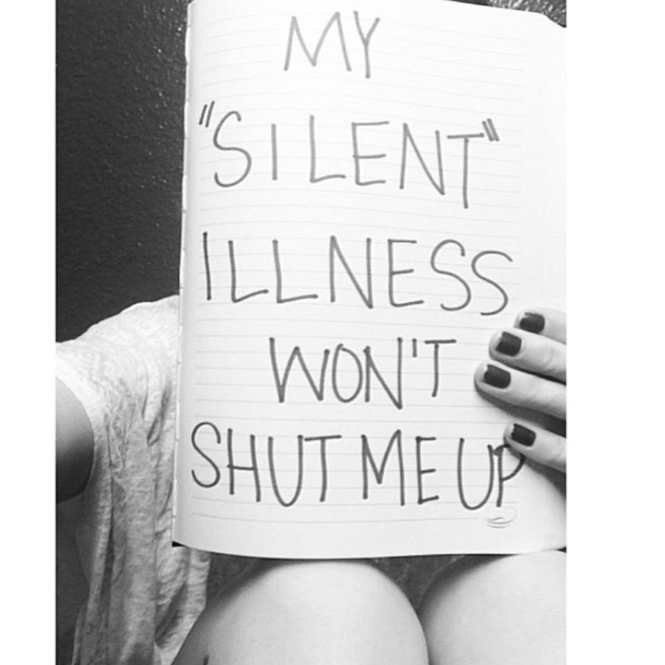 black and white photo of a woman holding up a sign that says "my 'silent' illness won't shut me up"