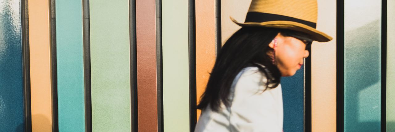 ‘Distress Tolerance’ in DBT Helped My Borderline Personality Disorder photo of asian woman cycling past colorful stripes on wall or window