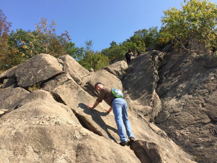 man climbing rocks