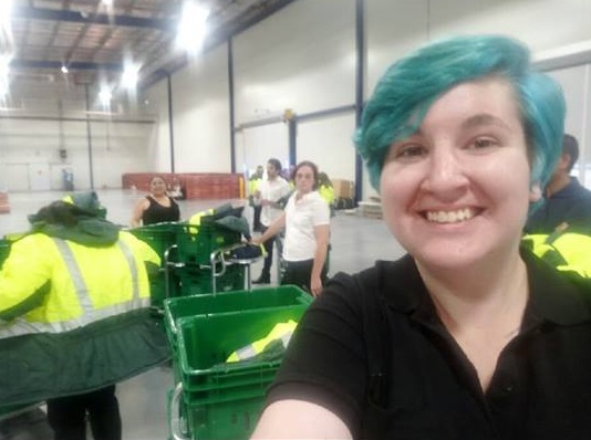 woman with blue hair working in warehouse