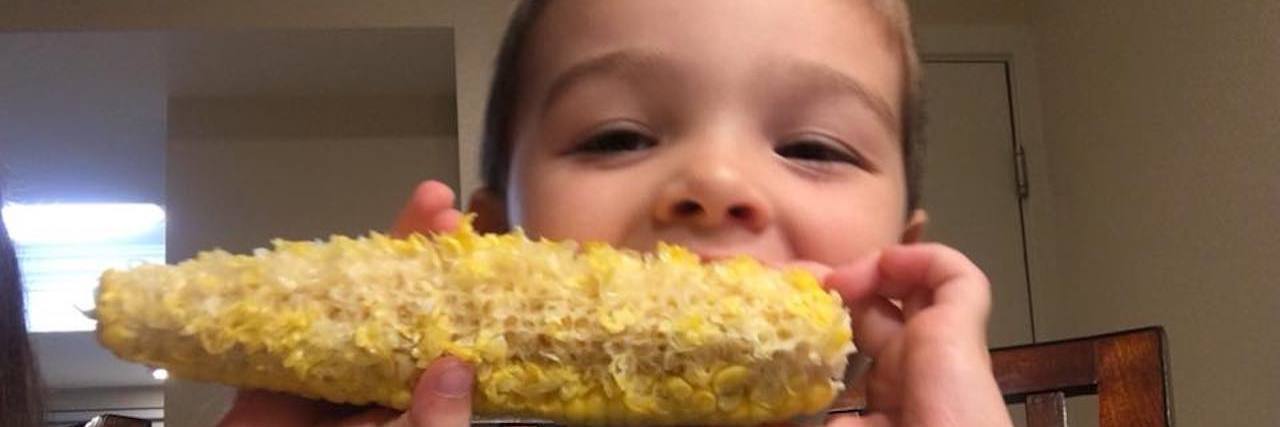 Boy eating corn on the cob