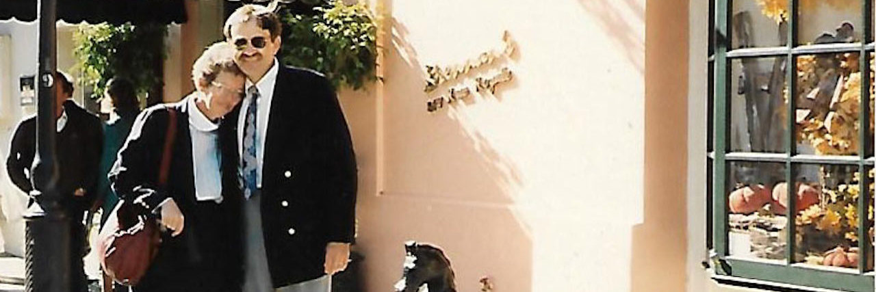 A man and his wife standing outside of a restaurant.