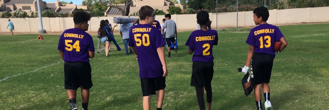 Back-to-School Talks When Your Child Has a Disability Backs of 4 students wearing football jerseys