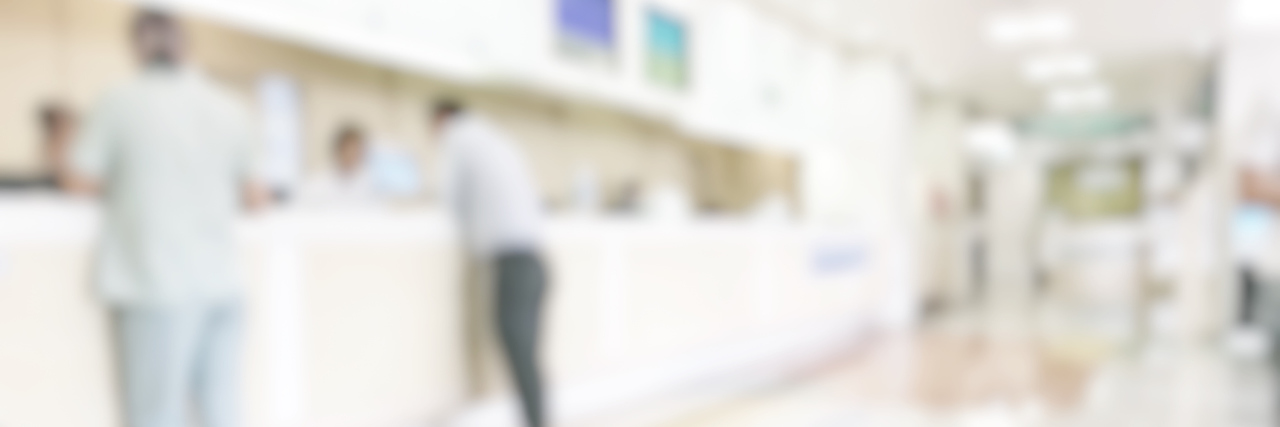 Medical blur background customer reception or patient service counter, office lobby in hospital clinic, or bank business building blurry interior inside waiting hall area