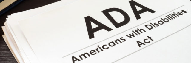 Americans with Disabilities Act paper next to keyboard.