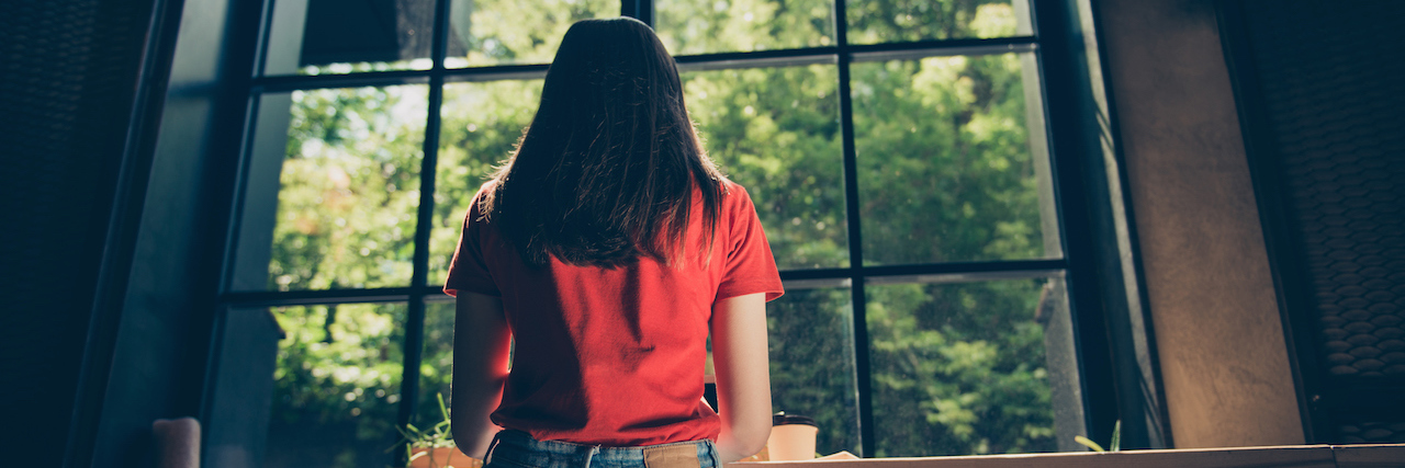 Turning to Alcohol After a Suicide Loss The back of a woman, sitting at a bar
