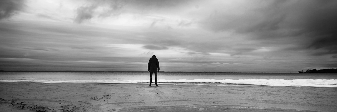 A silhousette of a man standing on a beach