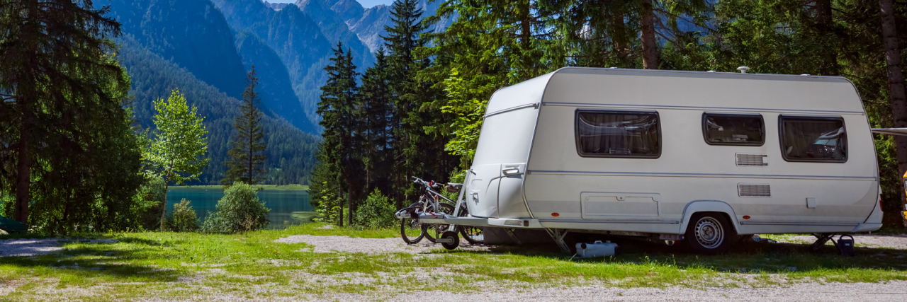 Camping With My Son on the Autism Spectrum Teaches Me About Parenting RV trailer outdoors