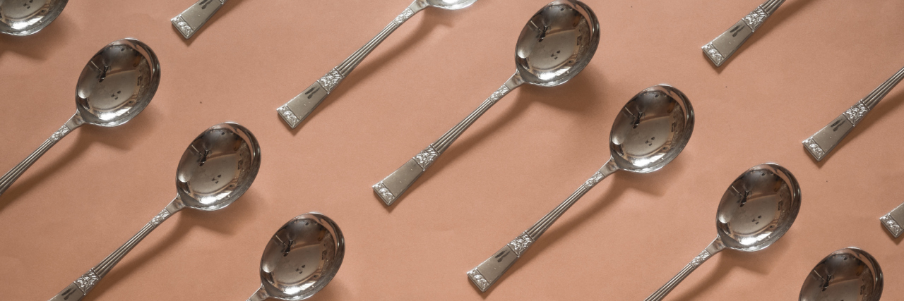 silver spoons on a cream background