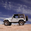 White Jeep on sand