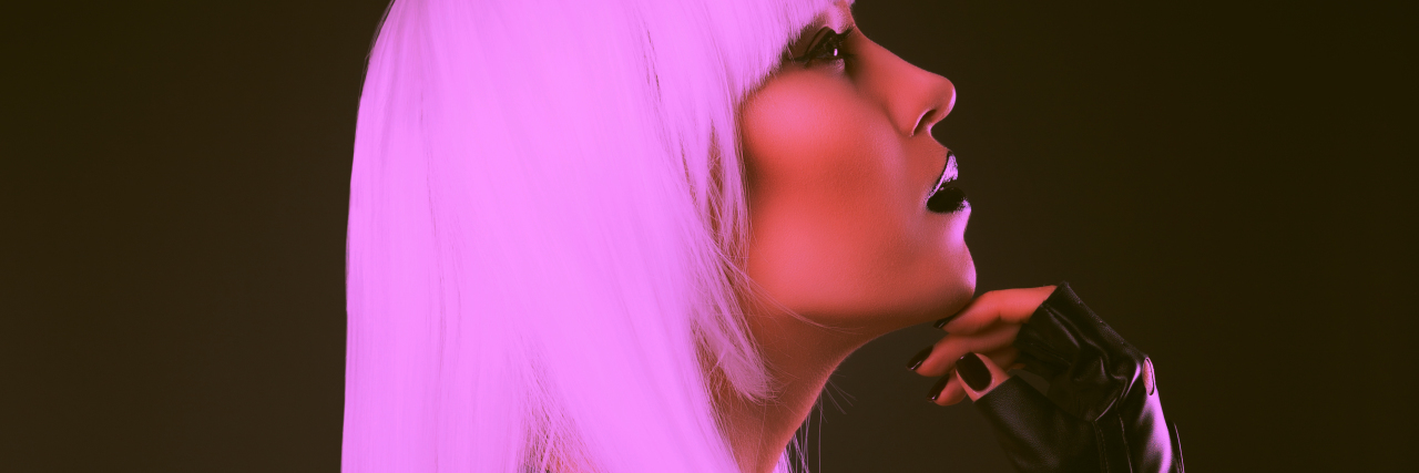 Deciding When to Talk About Invisible Illness Woman wearing black fingerless gloves.