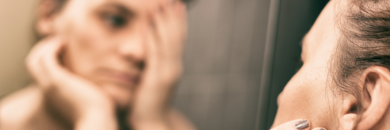 Dear Treatment-Resistant Major Depressive Disorder a sad woman looking at herself in mirror