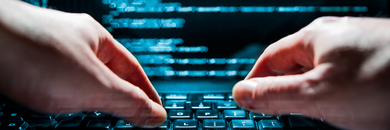 Disability, Mental Health Groups Oppose Florida Student Database Hacker using laptop. Lots of digits on the computer screen.