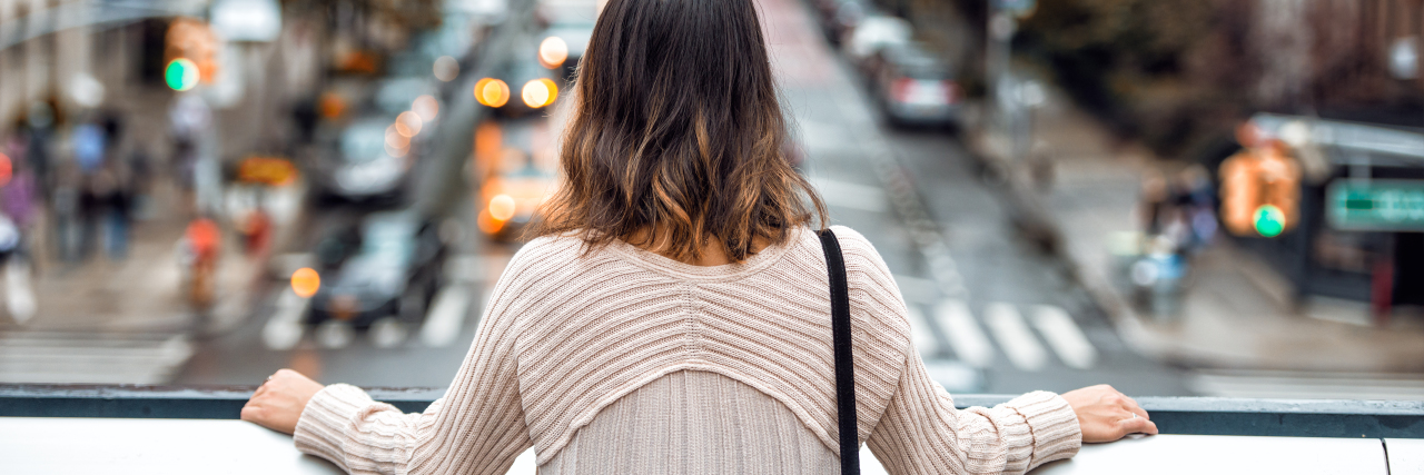 Why Generalized Anxiety Disorder Makes Me Constantly Question My Mind a woman looking down toward a city street